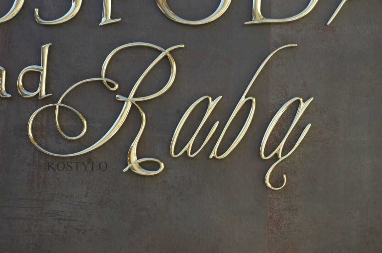 closeup of unique brass corporate artistic looking brass letters polished to high shine handcrafted designed handcrafted by Kostylo atelier