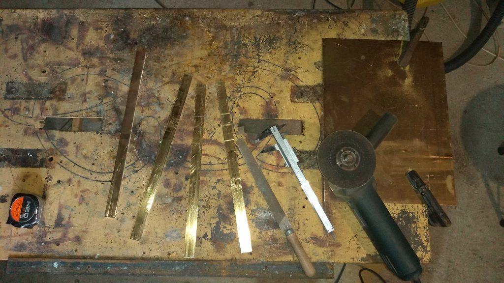 how_we_create_luxurious_belt_buckle_by_hand_cutting_brass_sheet_into_strips_to_size_in_kostylo_atelier cutting strips from brass sheets and cutting trouser buckle elements to size, which in the next process will be silver soldered and hand-grinded in the Kostylo atelier