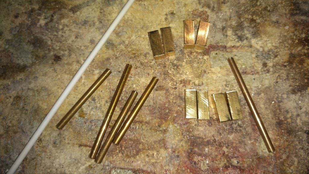 how_we_create_luxurious_belt_buckle_cut_pieces_for_buckle_with_leather_strap_fastenings_at_the_back_hand_crafted_by_kostylo_atelier prepared brass elements sized before silver soldering on the back of the belt buckle, everything handmade only in the Kostylo atelier