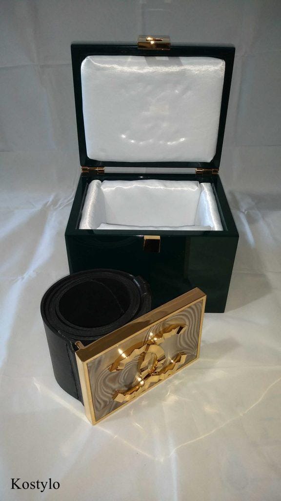 luxurious_gold_plated_buckle_belt_logo_coco_chanel_by_kostylo_atelier luxury gold-plated buckle for an exclusive skirt and dress with gold-plated Coco Chanel logo and striped flint stone next to it, in branded box lined with satin handmade by atelier Kostylo