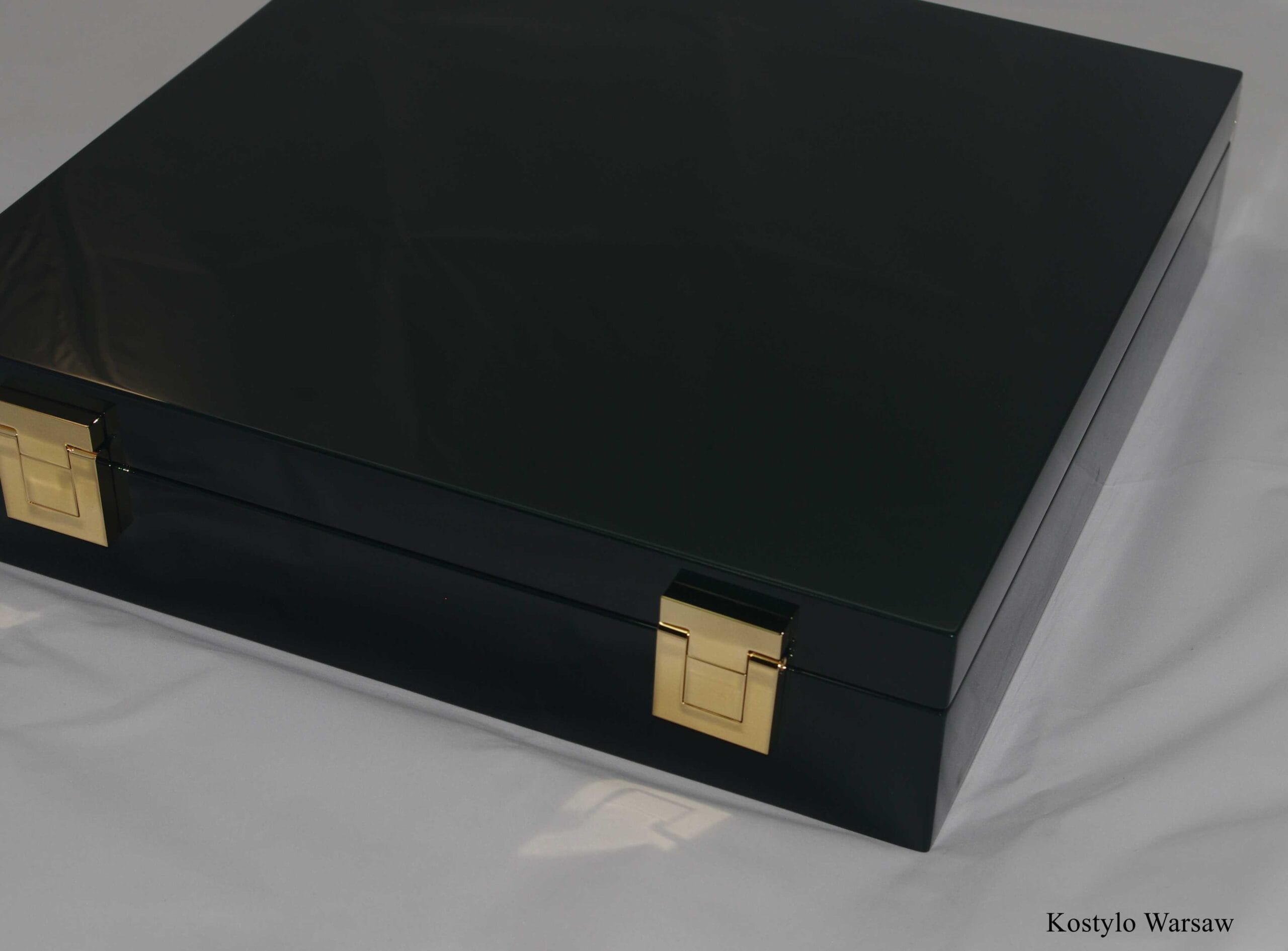 luxury dark green box with gold latches for luxurious gold modern wall clock designed and handmade by Kostylo