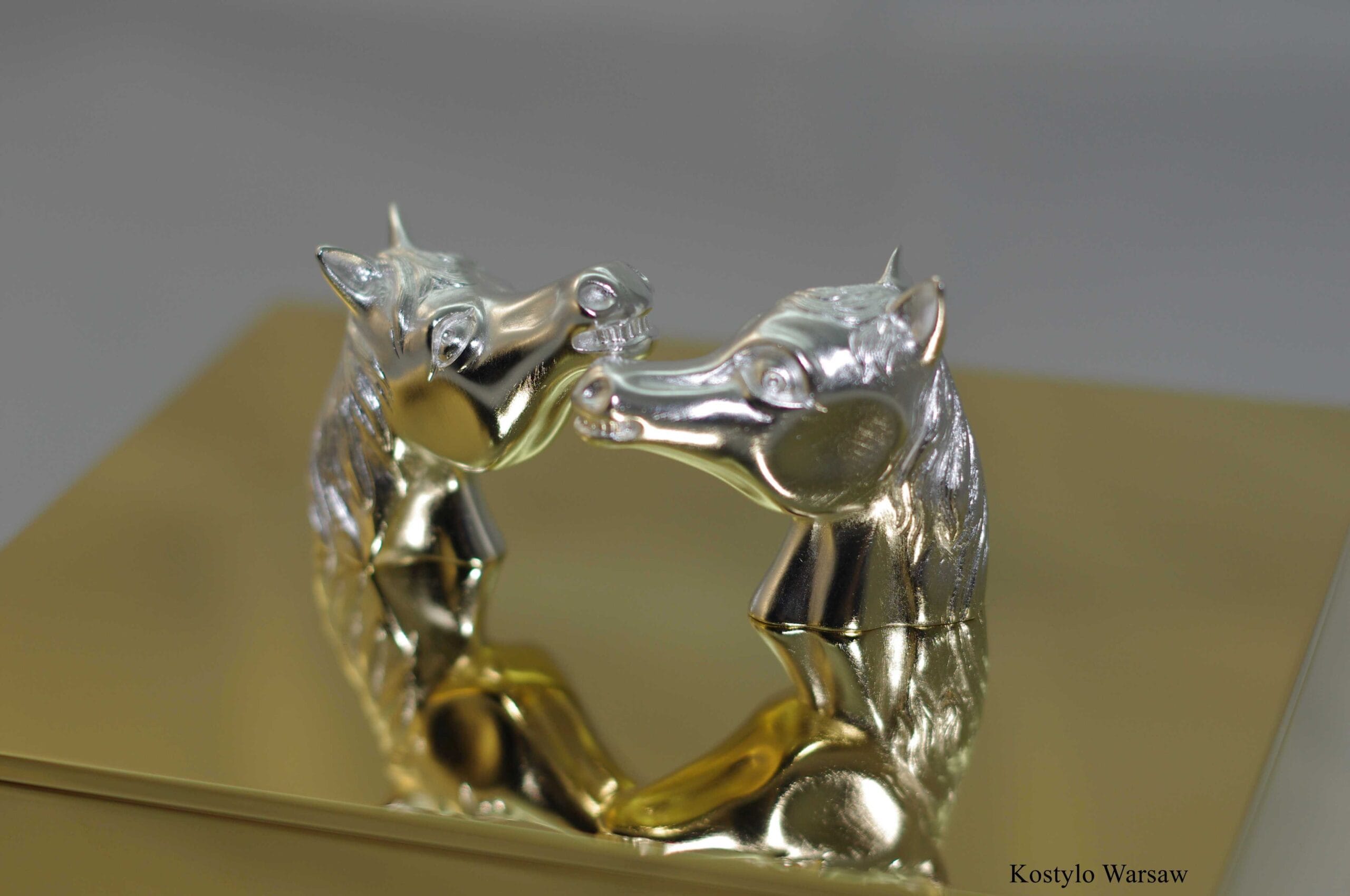 hand-carved and silverplated arabian horse heads hugging each other in the form of the handle of a luxurious gilded box by kostylo atelier