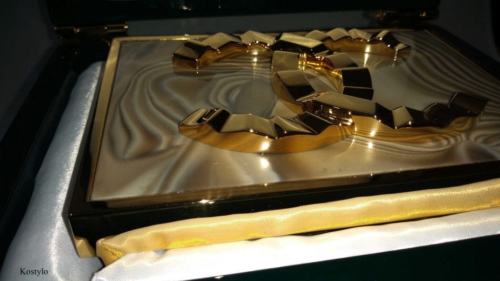 luxury_goldplated_coco_chanel_belt_authored_kostylo_atelier closeup of unique luxurious goldplated striped flint dress buckle with an unusual wavy Coco Chanel logo handcrafted by Kostylo atelier